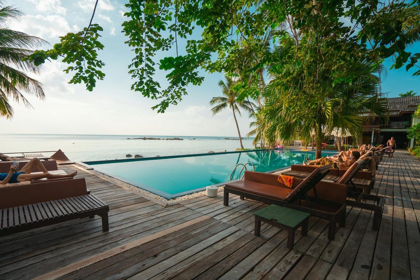 Pool deck with loungers looking out to sea